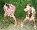 Girl helping to the  other to piss bending body.