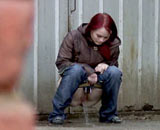 Girl peeing through her shorts