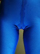 Tall goddess in a kinky blue rubber suit