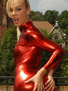 Blonde latex nun stuffing a black dildo