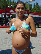 Pregnant chick shows her pussy and butthole, squeezes her tits and rides a long glassy dildo
